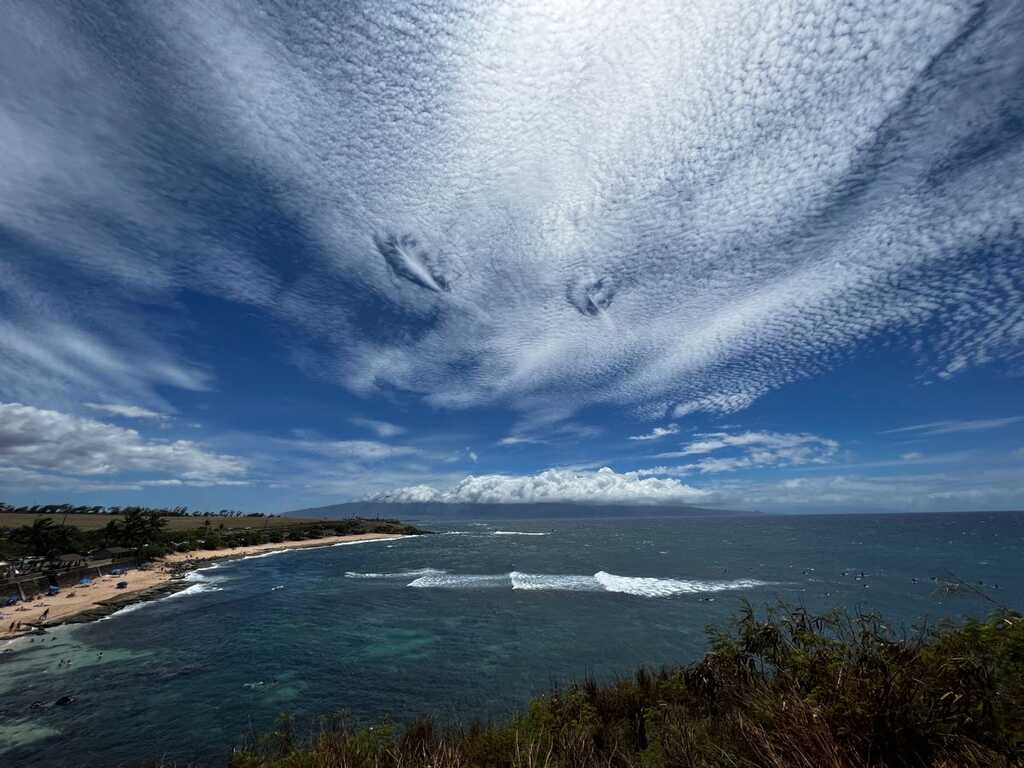 A photo of two cloud formations known as Fallstreak Holes over the waters of Ho'okipa Beach Park on the island of Maui, in the state of Hawaii — Weekend Weather Conditions Across Hawaiian Islands for May 16-17, 2026 | Maui Tom's News