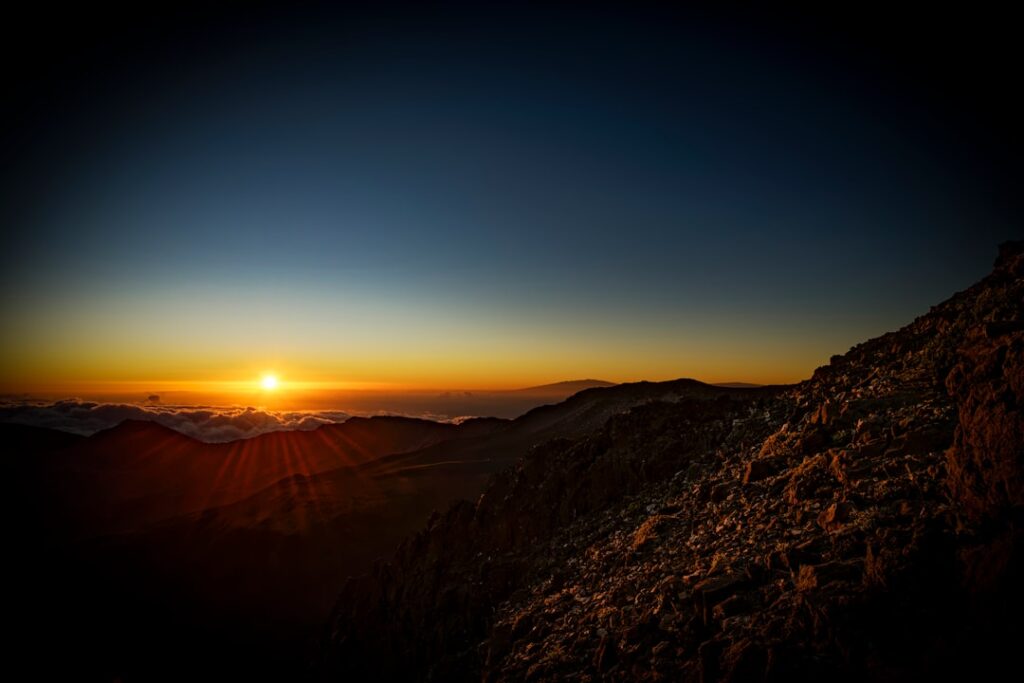 Sunrise over a mountain range with clouds — New Leadership Named for State Land and Natural Resources Department | Maui Tom's News