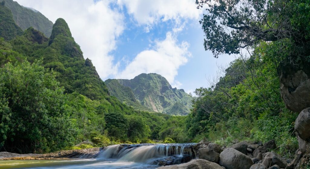 Mountains and lush greenery overlook a small waterfall. — East Maui Water Authority Grant Workshop Rescheduled to Sept. 2 | Maui Tom's News