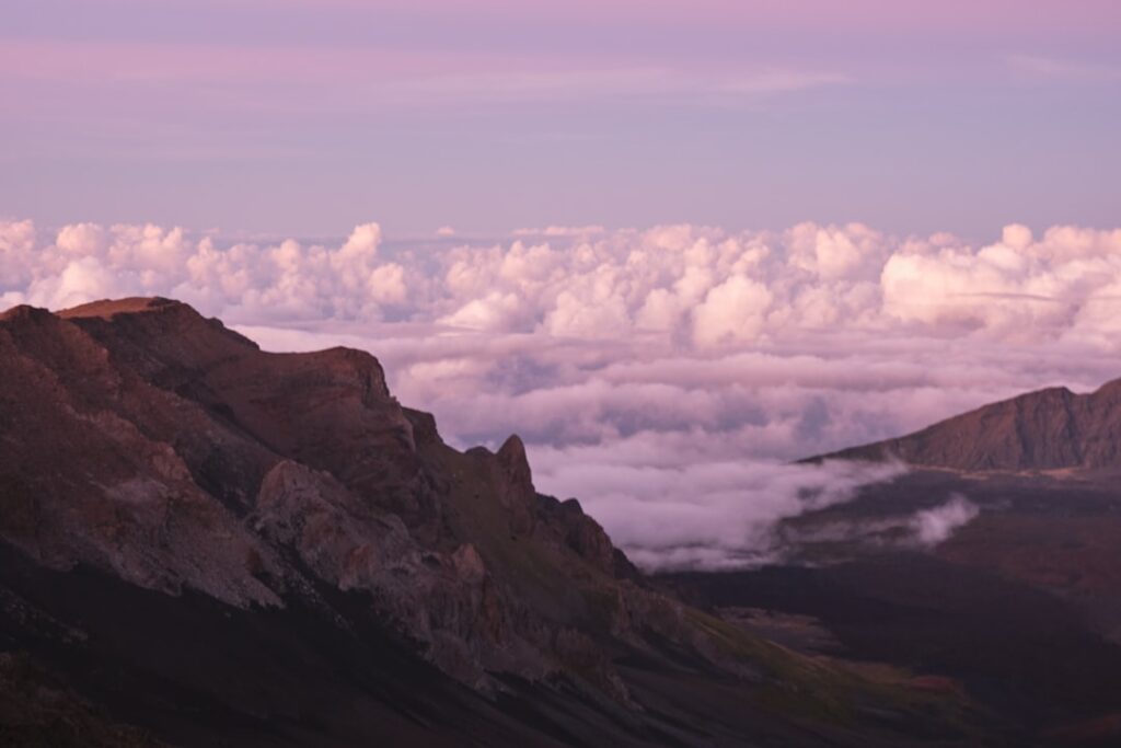 a view of the mountains and clouds from the top of a mountain — Maui County Takes Over State Wildfire Case Management Program | Maui Tom's News